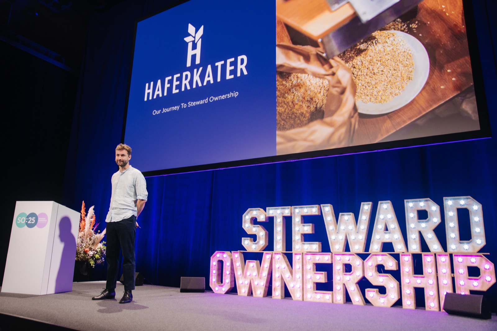 A founder presenting their company&rsquo;s journey to steward ownership on stage at a PURPOSE Steward Ownership event